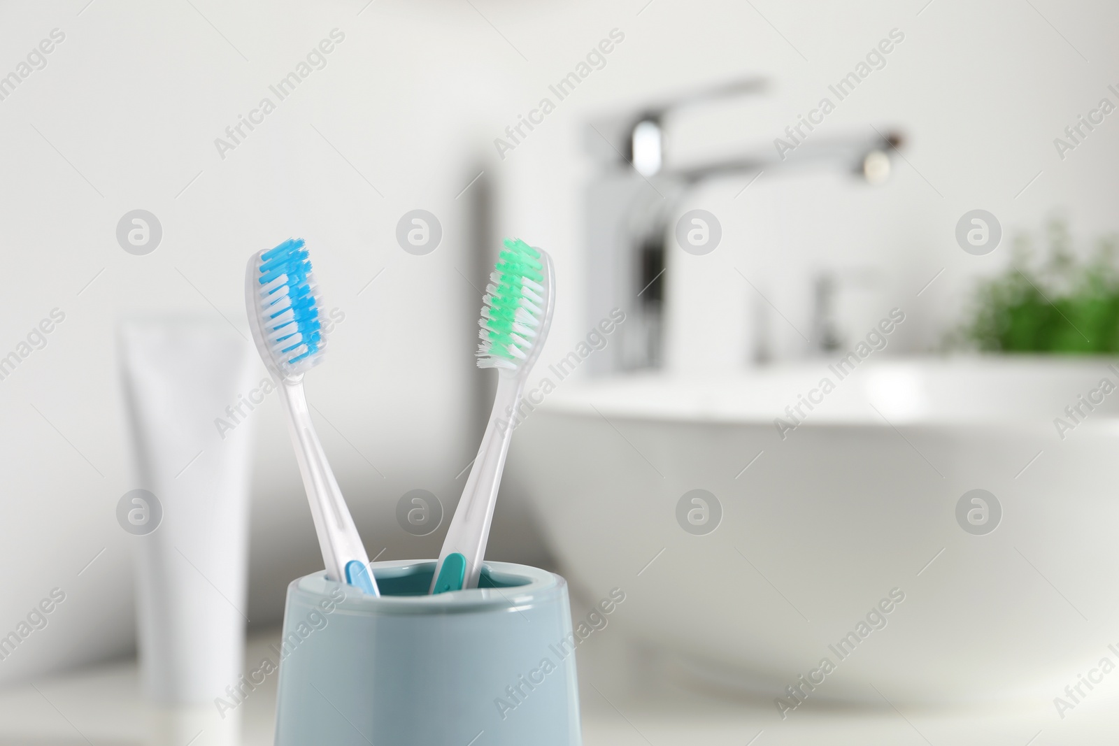 Photo of Plastic toothbrushes on blurred background, closeup. Space for text