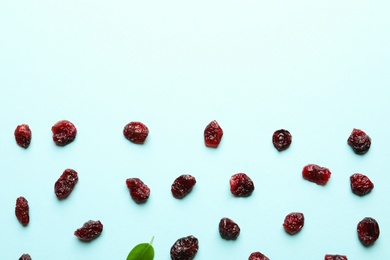 Photo of Flat lay composition of cranberries on color background, space for text. Dried fruit as healthy snack