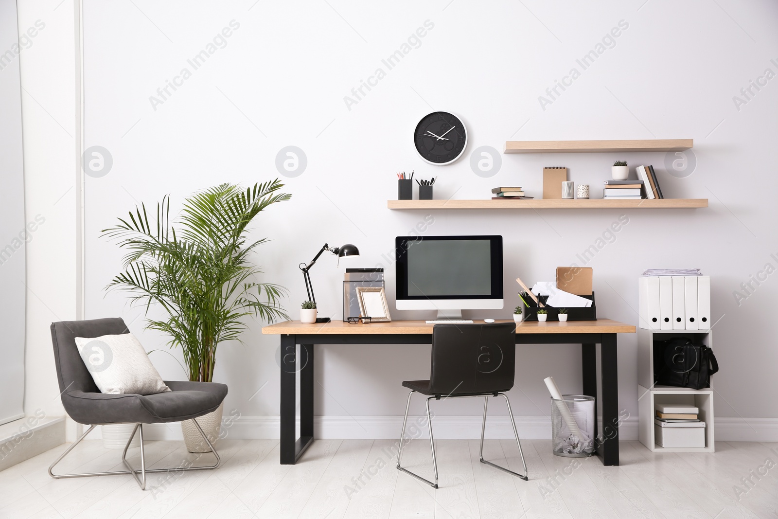 Photo of Modern computer on table in office interior. Stylish workplace