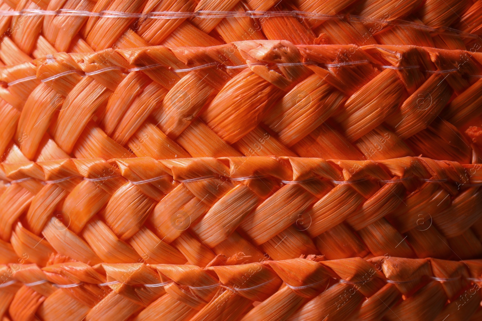 Photo of Orange wicker woven texture as background, closeup