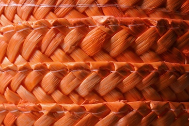 Photo of Orange wicker woven texture as background, closeup