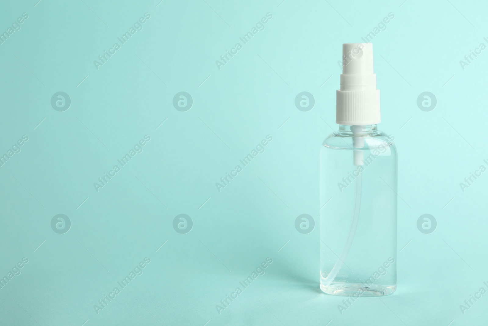 Photo of Antiseptic spray on light blue background. Space for text