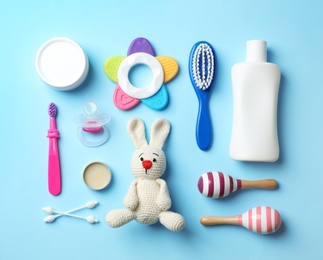 Photo of Flat lay composition with baby accessories and toys on color background