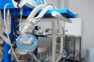 Photo of Oxygen mask as part of artificial lungs ventilation machine in surgery room, closeup. Space for text