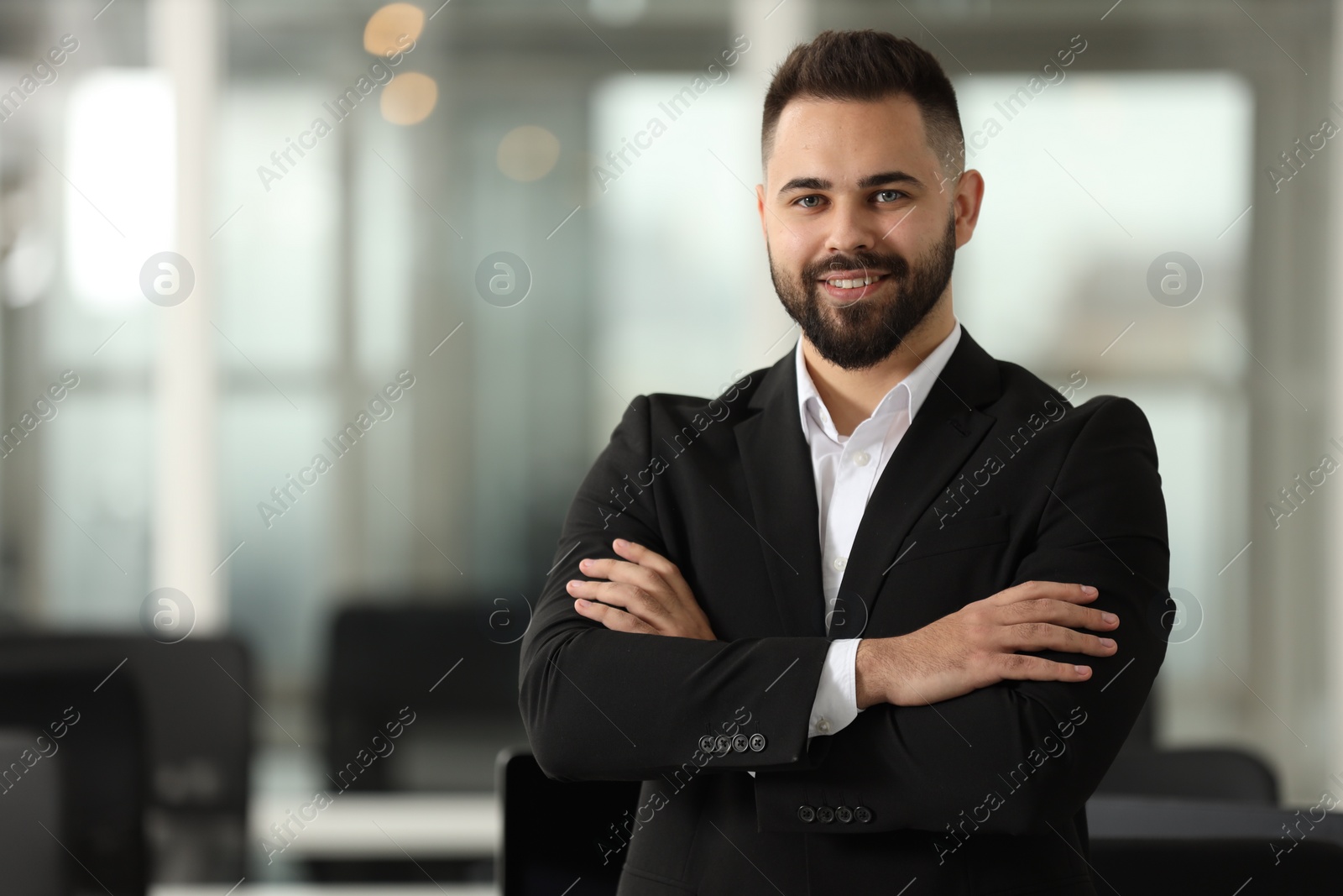 Photo of Portrait of smiling man with crossed arms in office, space for text. Lawyer, businessman, accountant or manager