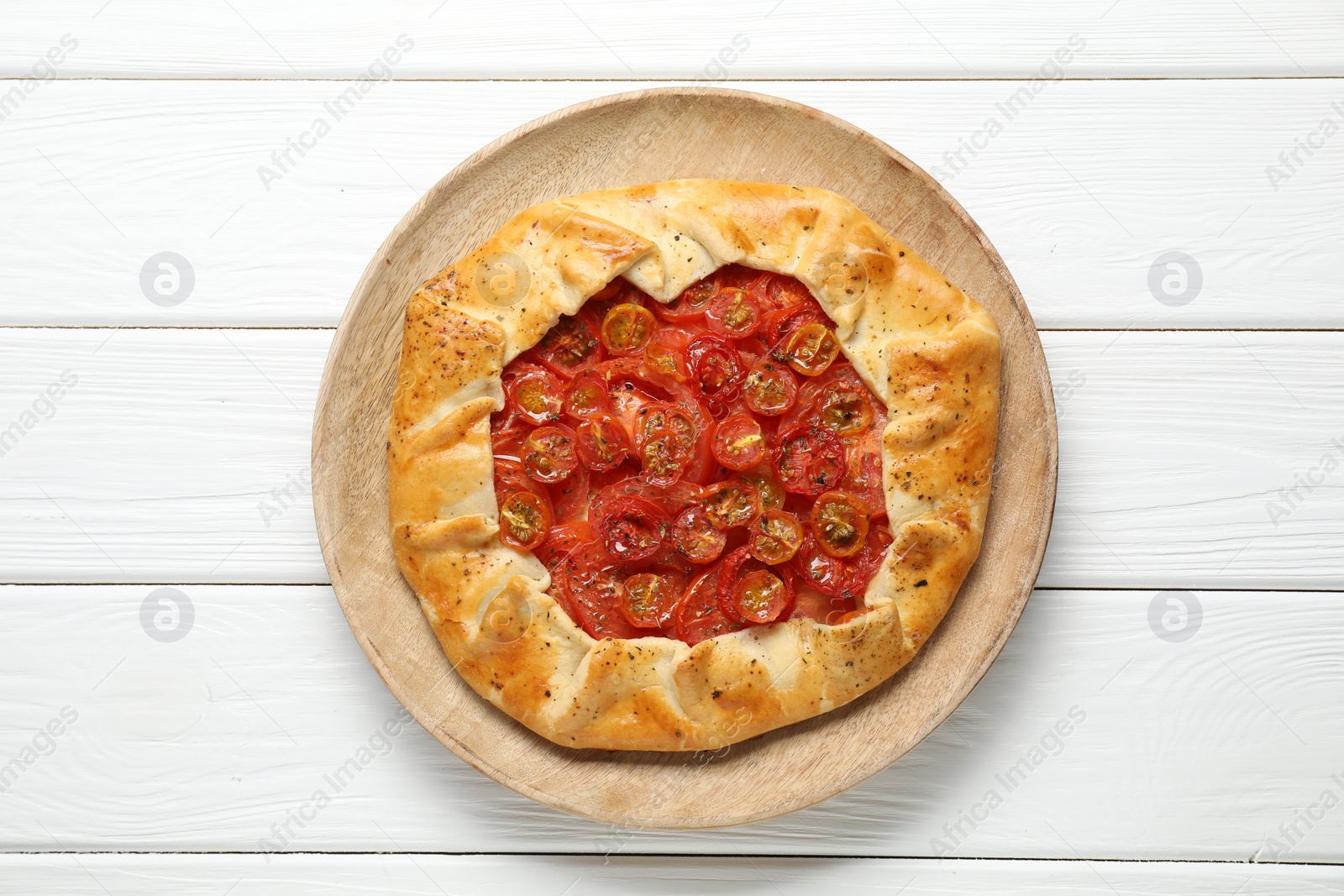 Photo of Tasty tomato galette (Caprese galette) on white wooden table, top view