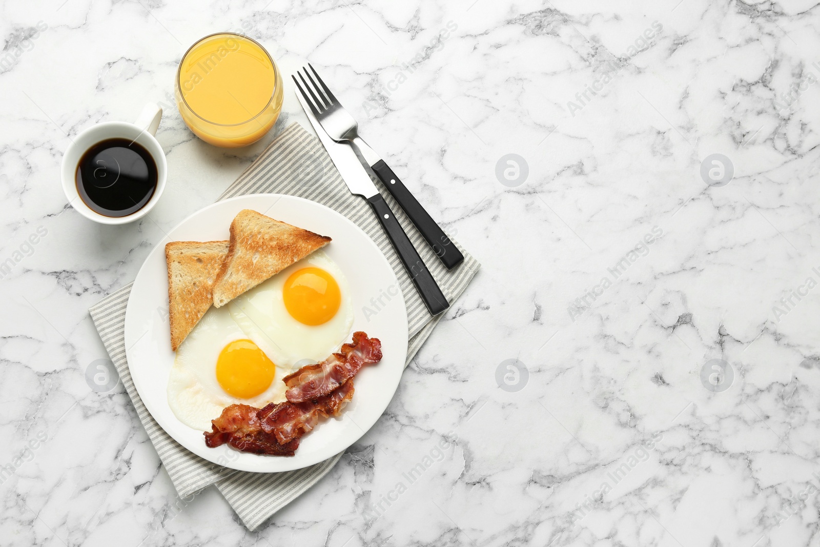 Photo of Delicious breakfast with sunny side up eggs served on white marble table, flat lay. Space for text
