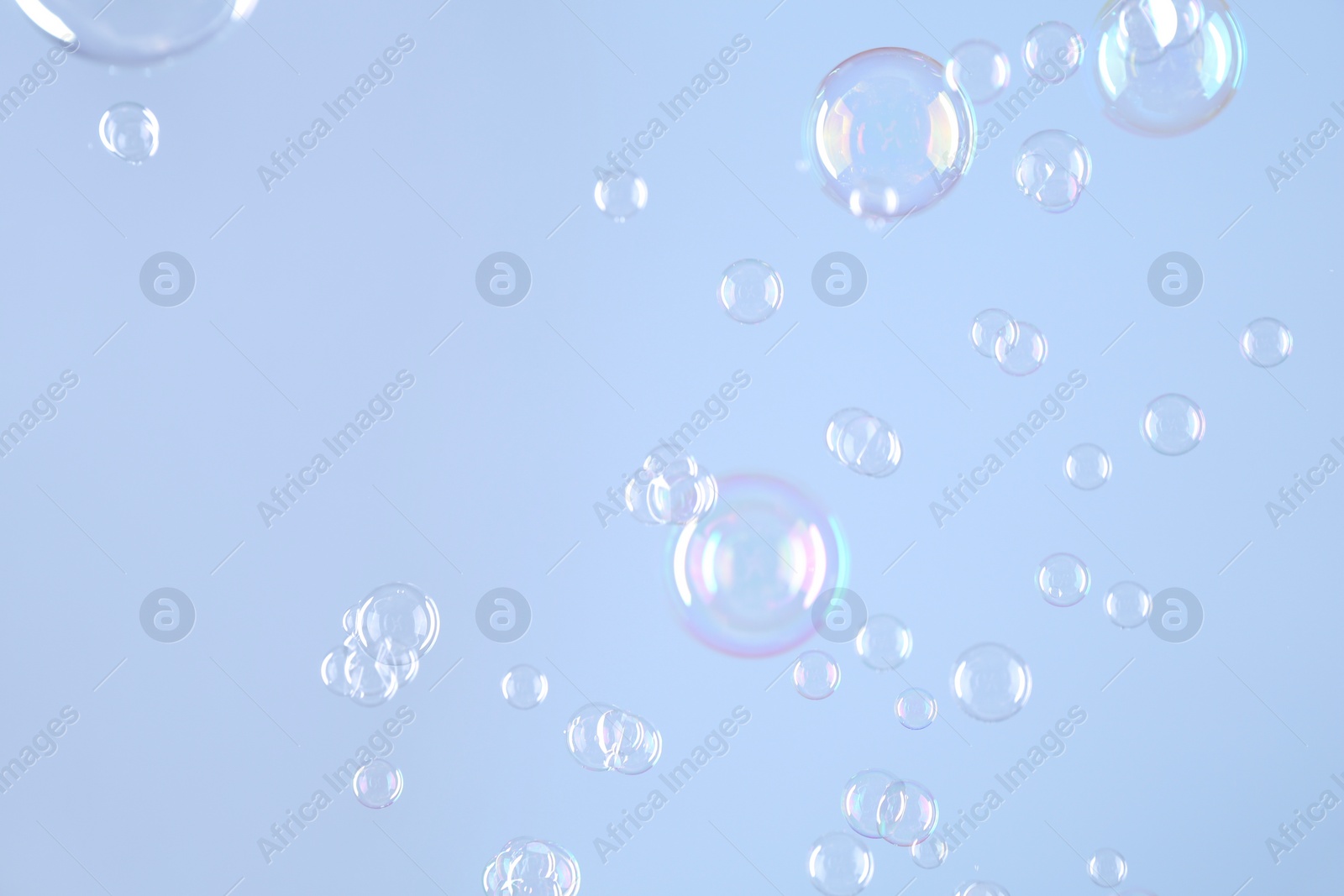 Photo of Beautiful transparent soap bubbles on light grey background