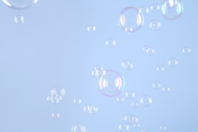 Beautiful transparent soap bubbles on light grey background