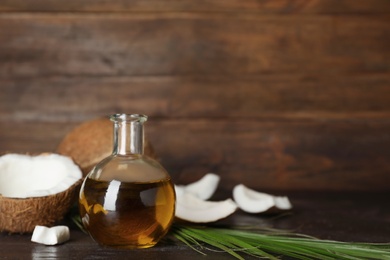 Photo of Composition with coconut oil on wooden table. Healthy cooking