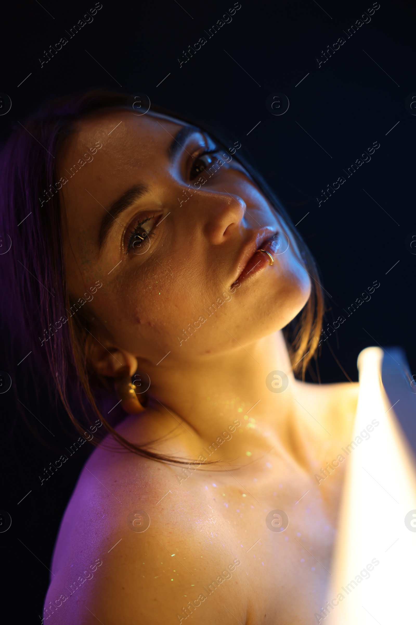 Photo of Beautiful woman on dark background in neon lights