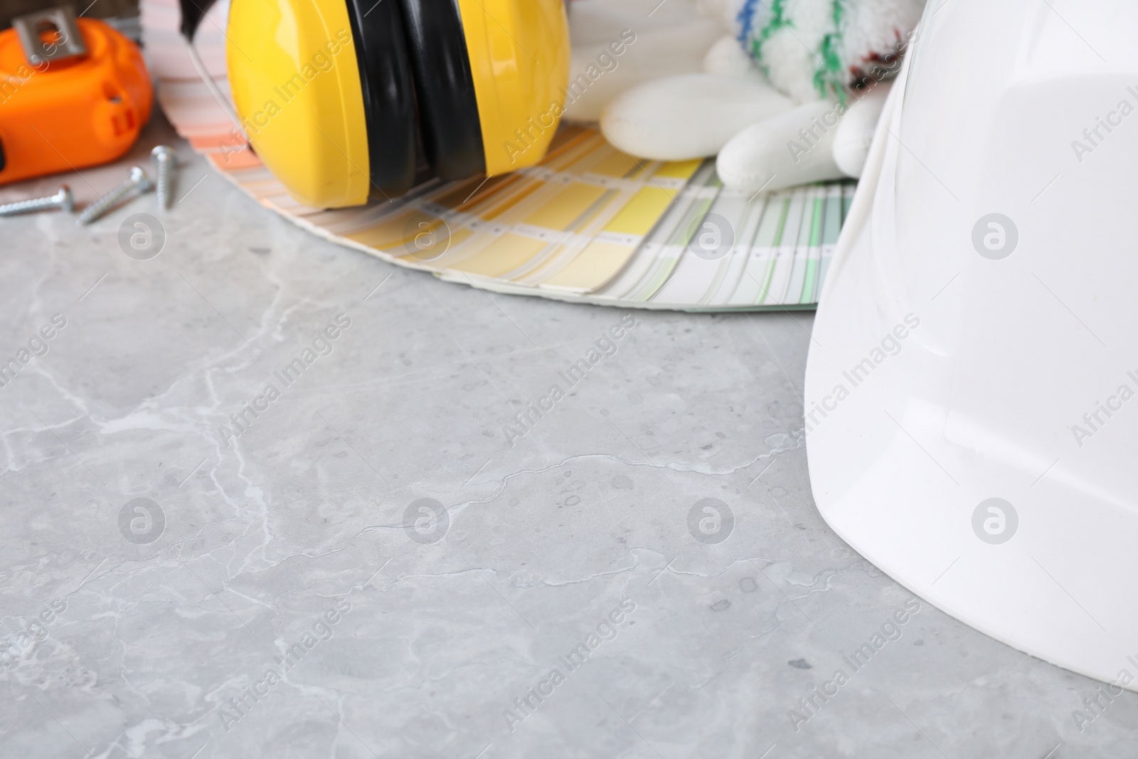 Photo of Different construction tools on marble background, space for text