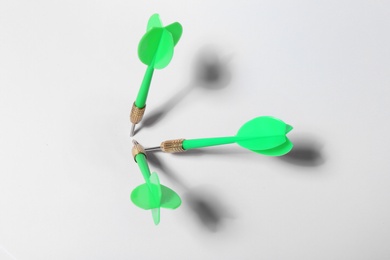 Photo of Green dart arrows for game on white background, above view