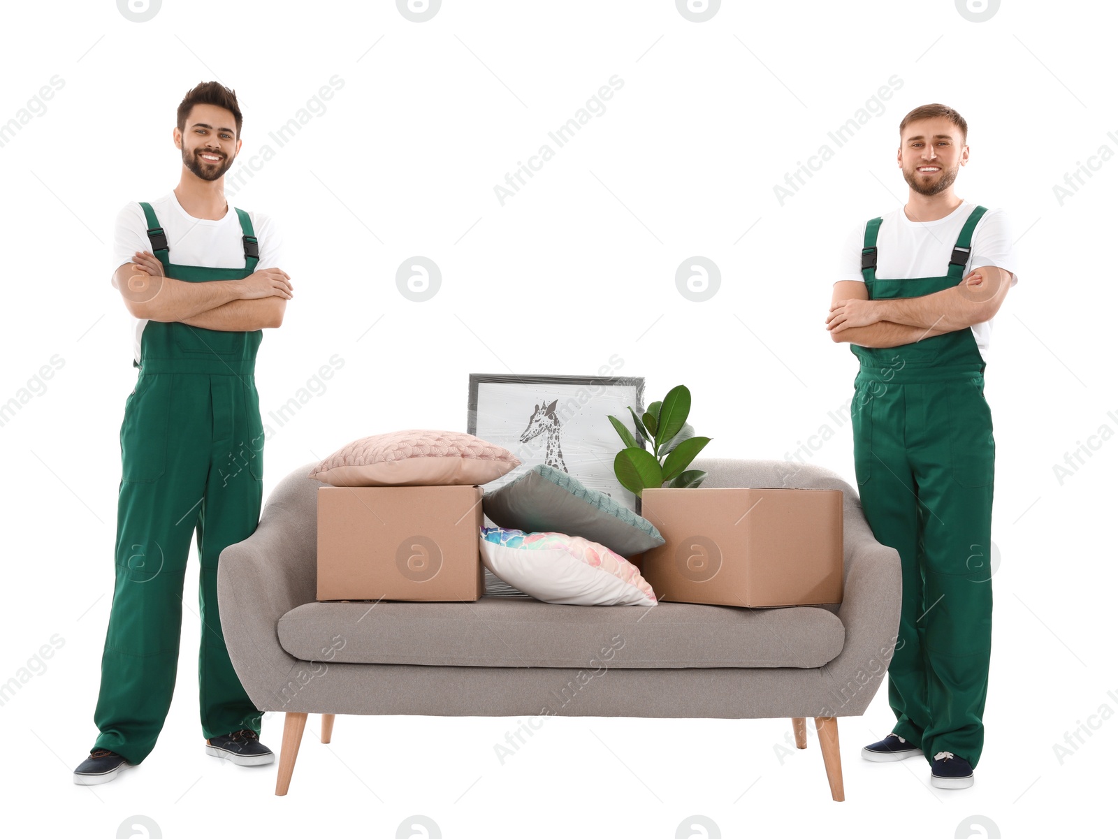 Photo of Young workers near sofa with stuff isolated on white. Moving service