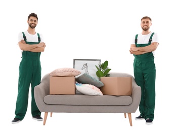 Young workers near sofa with stuff isolated on white. Moving service