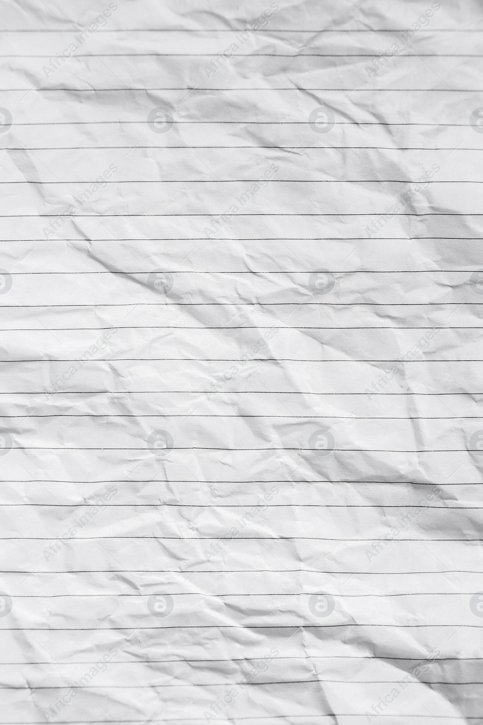 Photo of Sheet of crumpled lined paper as background, top view
