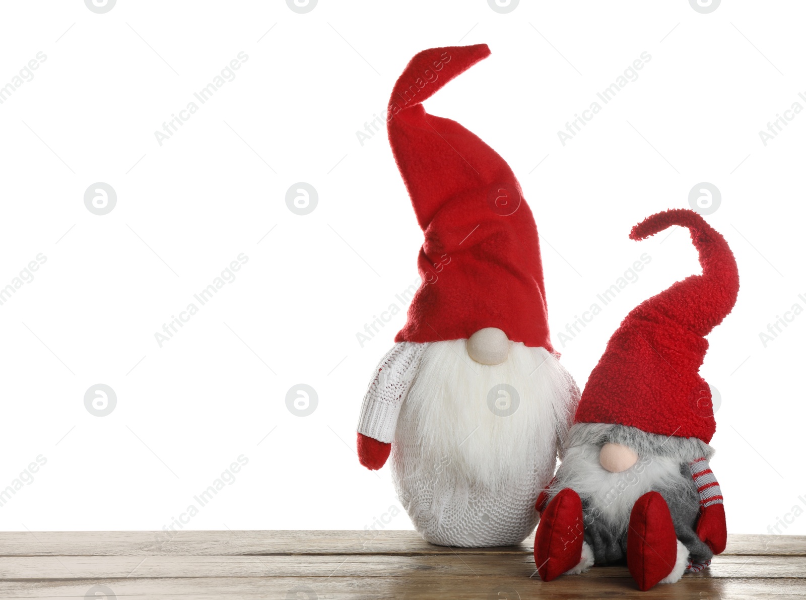 Photo of Funny Christmas gnomes on wooden table against white background. Space for text