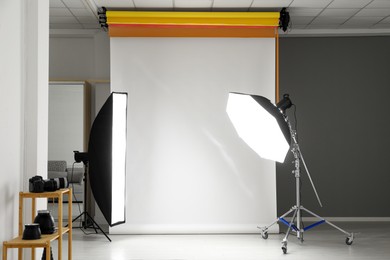 Photo of White photo background and professional lighting equipment in studio