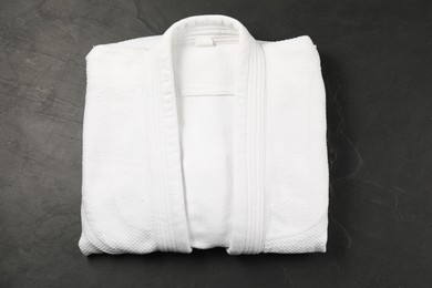 Photo of White kimono on gray background, top view