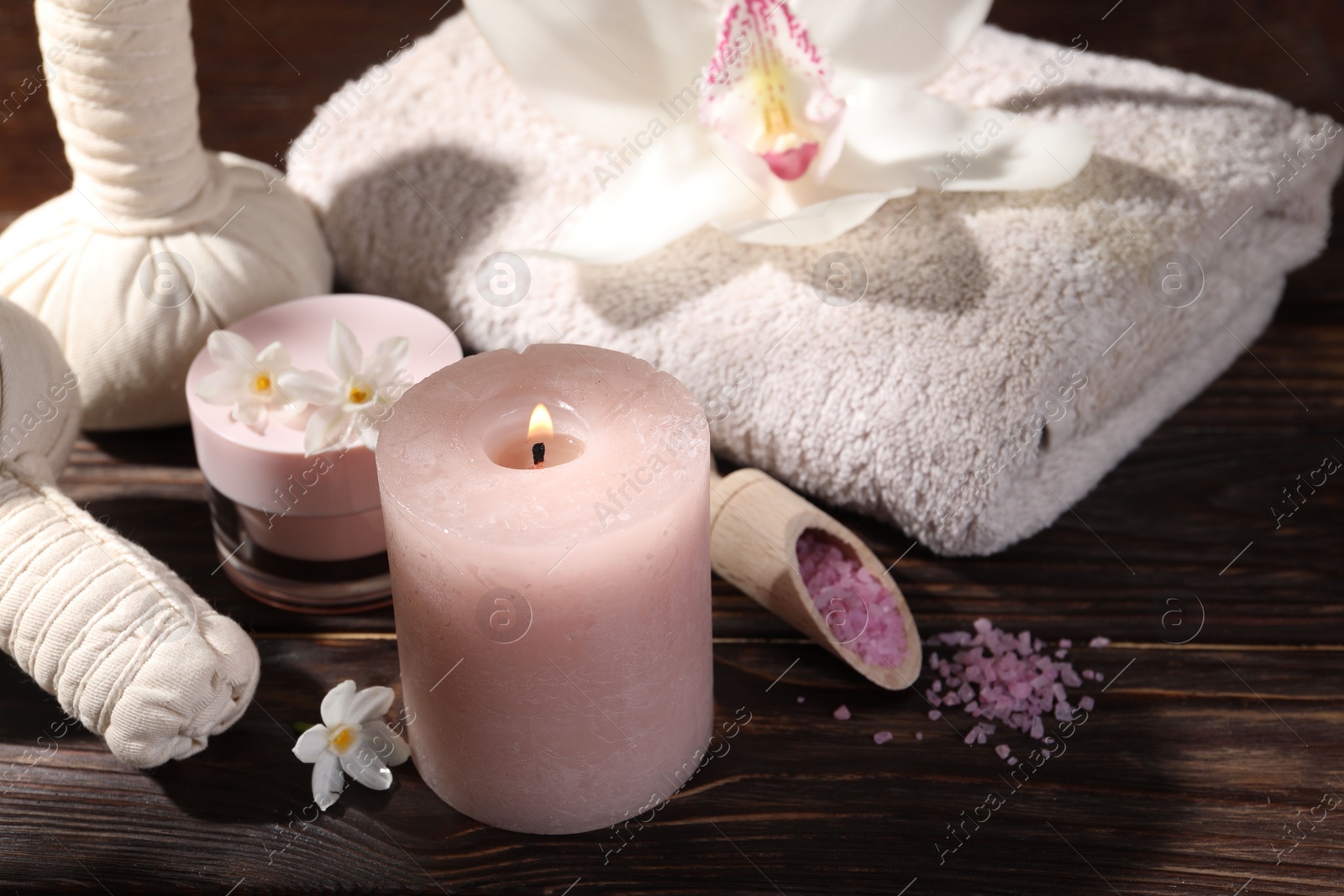 Photo of Composition with spa supplies and flowers on wooden table