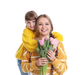 Photo of Happy mother and daughter with flower bouquet on white background. International Women's Day