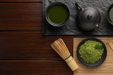 Photo of Flat lay composition with green matcha powder on wooden table, space for text