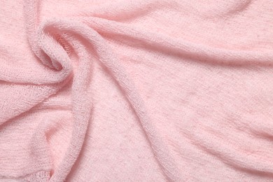 Photo of Texture of soft pink crumpled fabric as background, top view