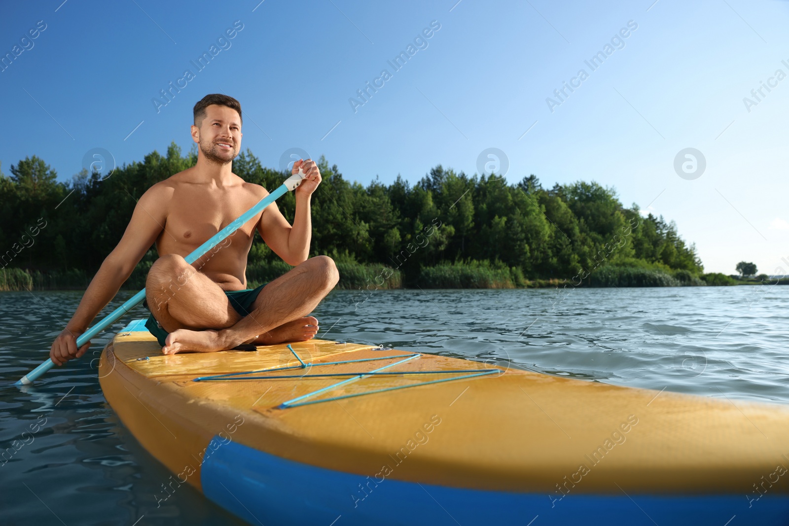 Photo of Man paddle boarding on SUP board in river