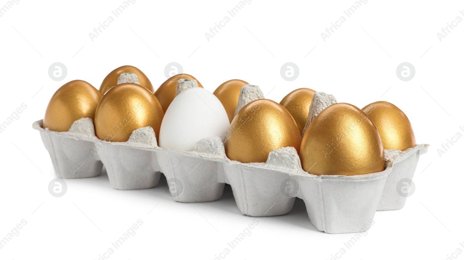 Photo of Carton with golden eggs and ordinary one on white background