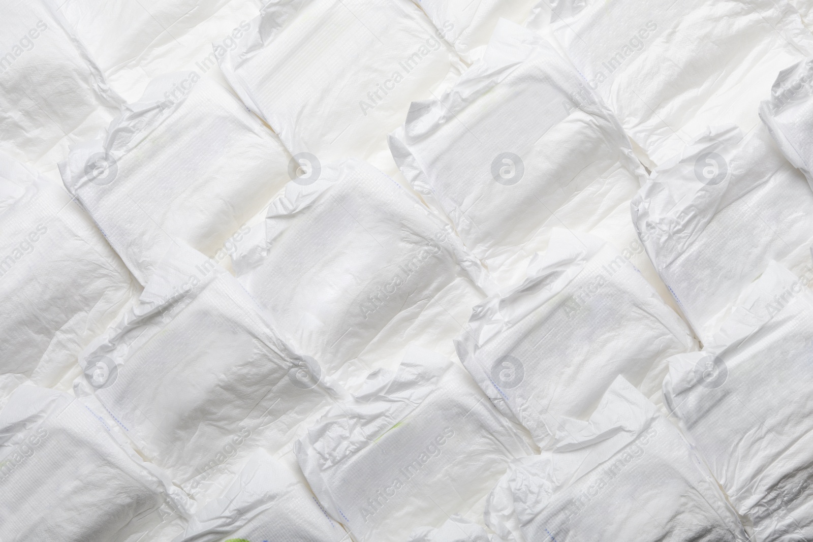 Photo of Baby diapers as background, top view. Child's garment