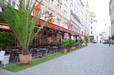 Photo of VIENNA, AUSTRIA - JUNE 18, 2018: Open-air restaurant on city street
