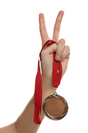 Photo of Woman holding silver medal on white background, closeup. Space for design