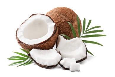 Photo of Fresh ripe coconuts with green leaves on white background