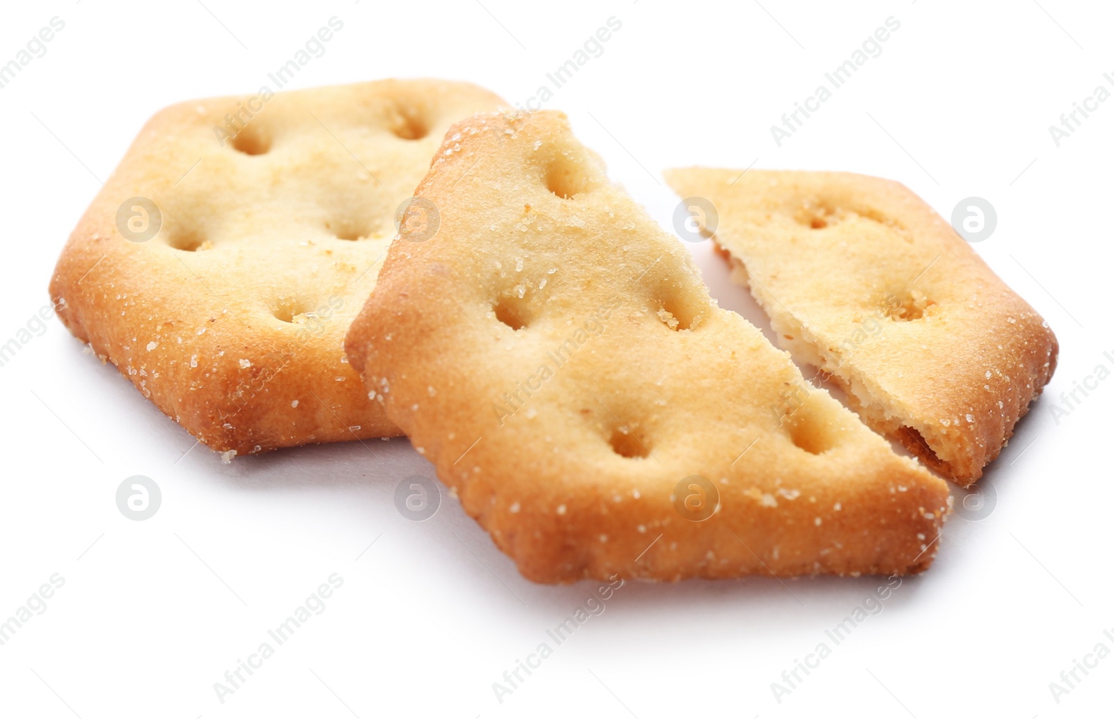 Photo of Crispy crackers isolated on white. Delicious snack