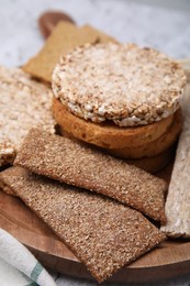 Photo of Rye crispbreads, rice cakes and rusks on table, closeup