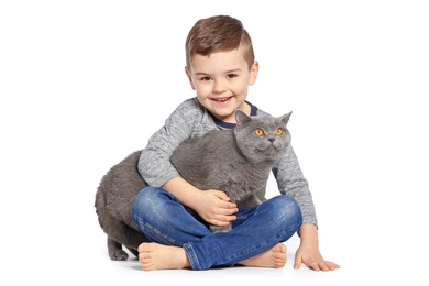 Photo of Cute little child with cat on white background