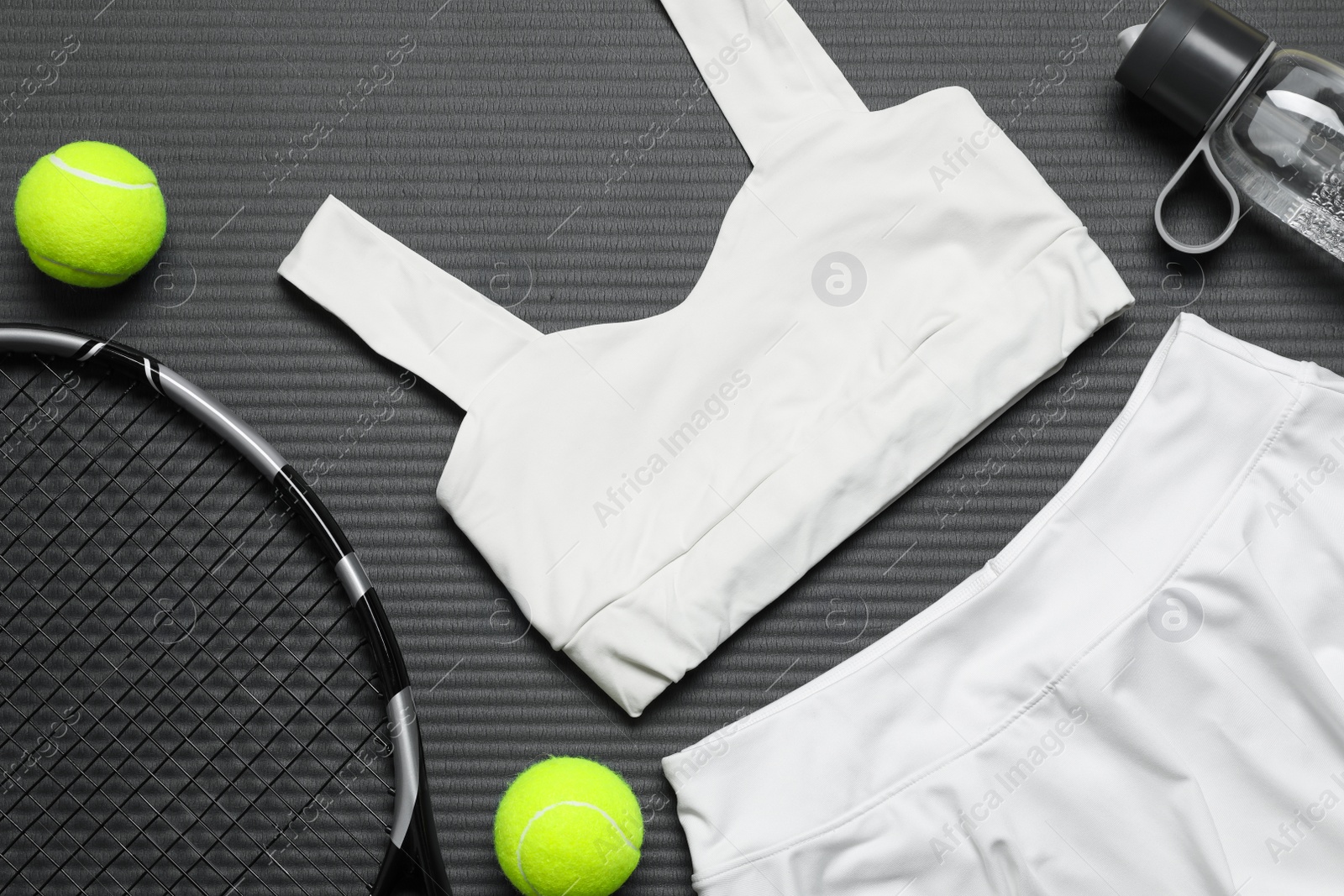 Photo of Flat lay composition with sports equipment on grey mat