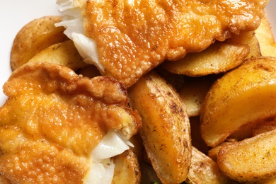 Photo of British traditional fish and potato chips, closeup