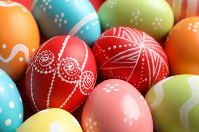 Photo of Colorful decorated Easter eggs as background, closeup