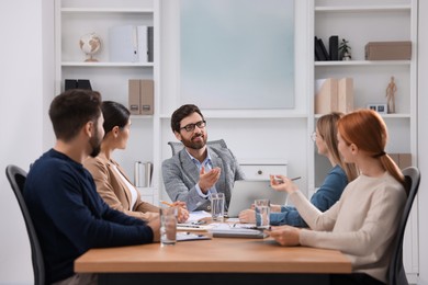 Team of employees working together in office