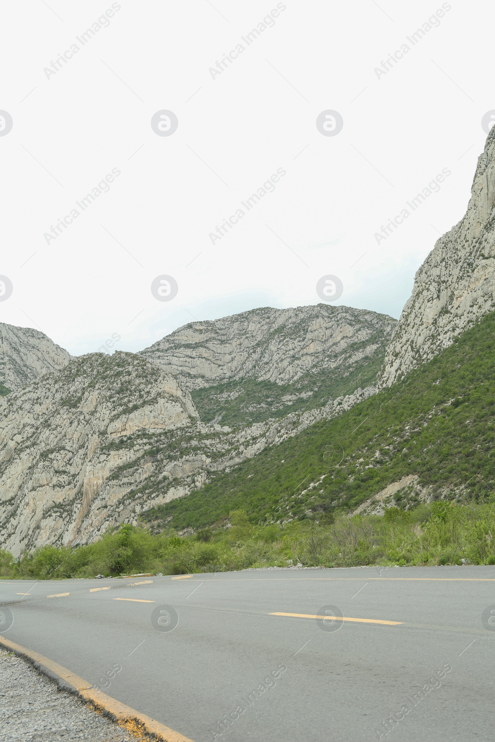 Photo of Picturesque landscape with mountains and asphalt highway outdoors. Road trip