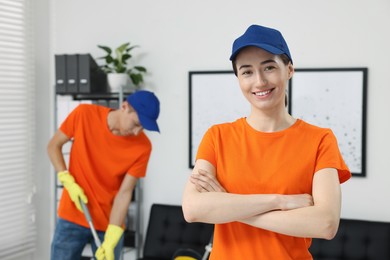 Photo of Portrait of cleaning service worker in office, selective focus