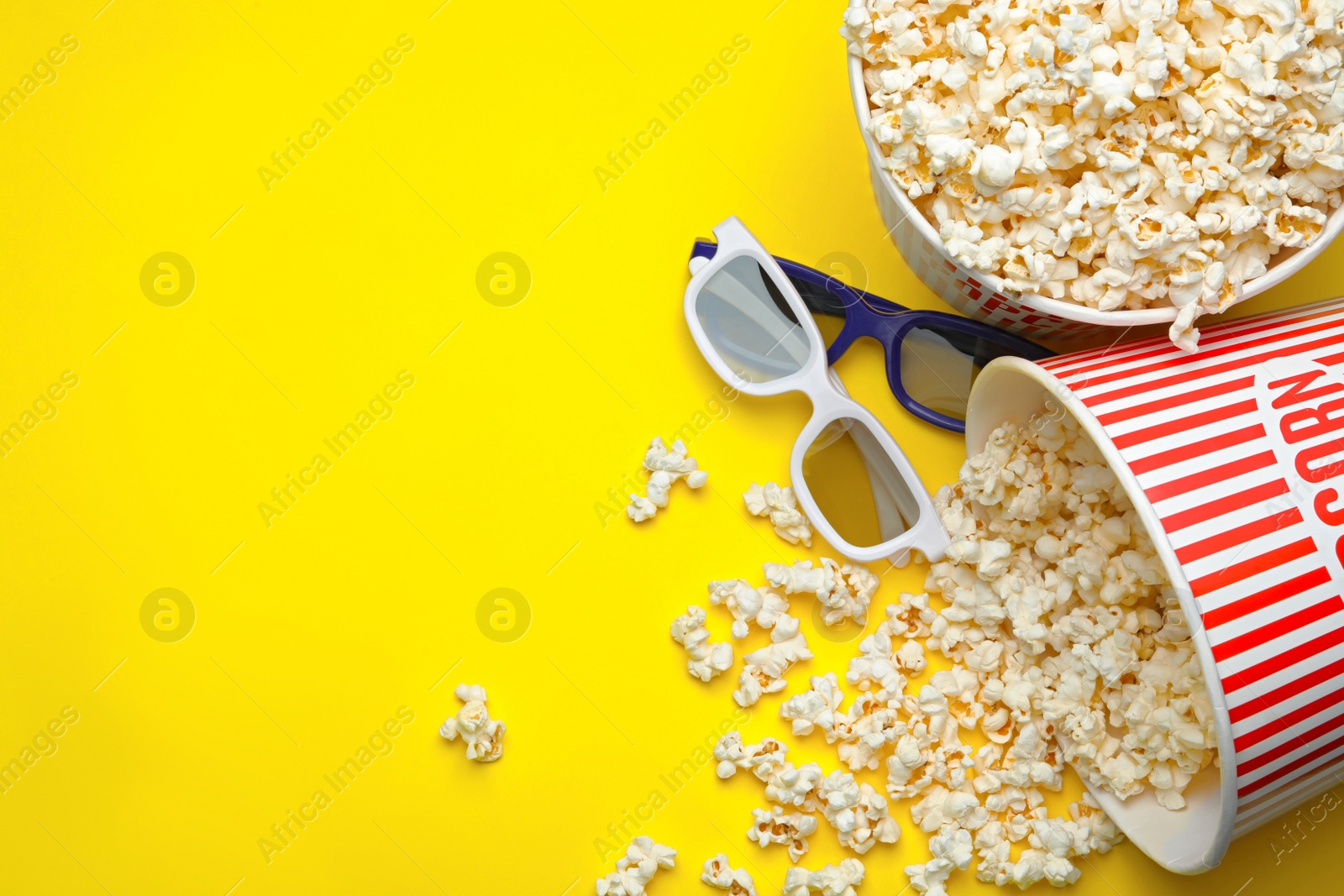 Photo of 3D glasses and popcorn on yellow background, flat lay with space for text. Cinema snack