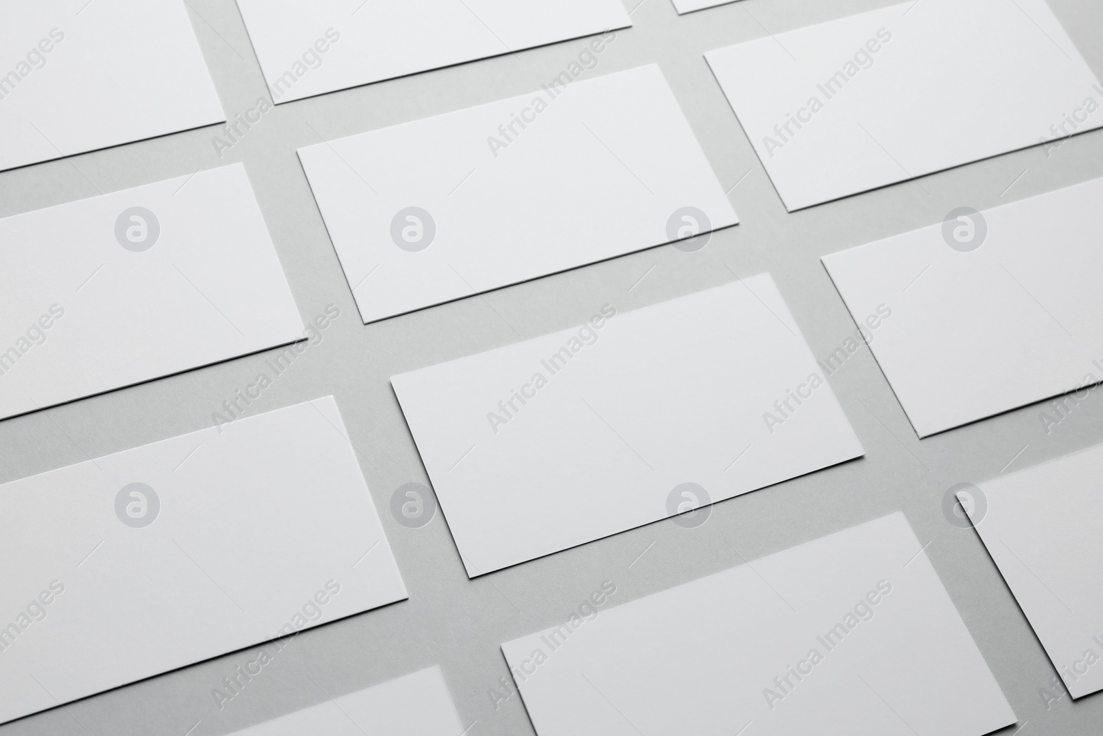 Photo of Blank business cards on light gray background, closeup. Mockup for design