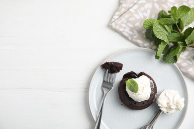 Photo of Delicious fresh fondant with hot chocolate and mint served on white wooden table, flat lay. Space for text