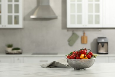 Fresh clean vegetables on white table in kitchen, space for text