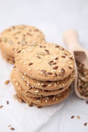 Photo of Cereal crackers with flax and sesame seeds on white table