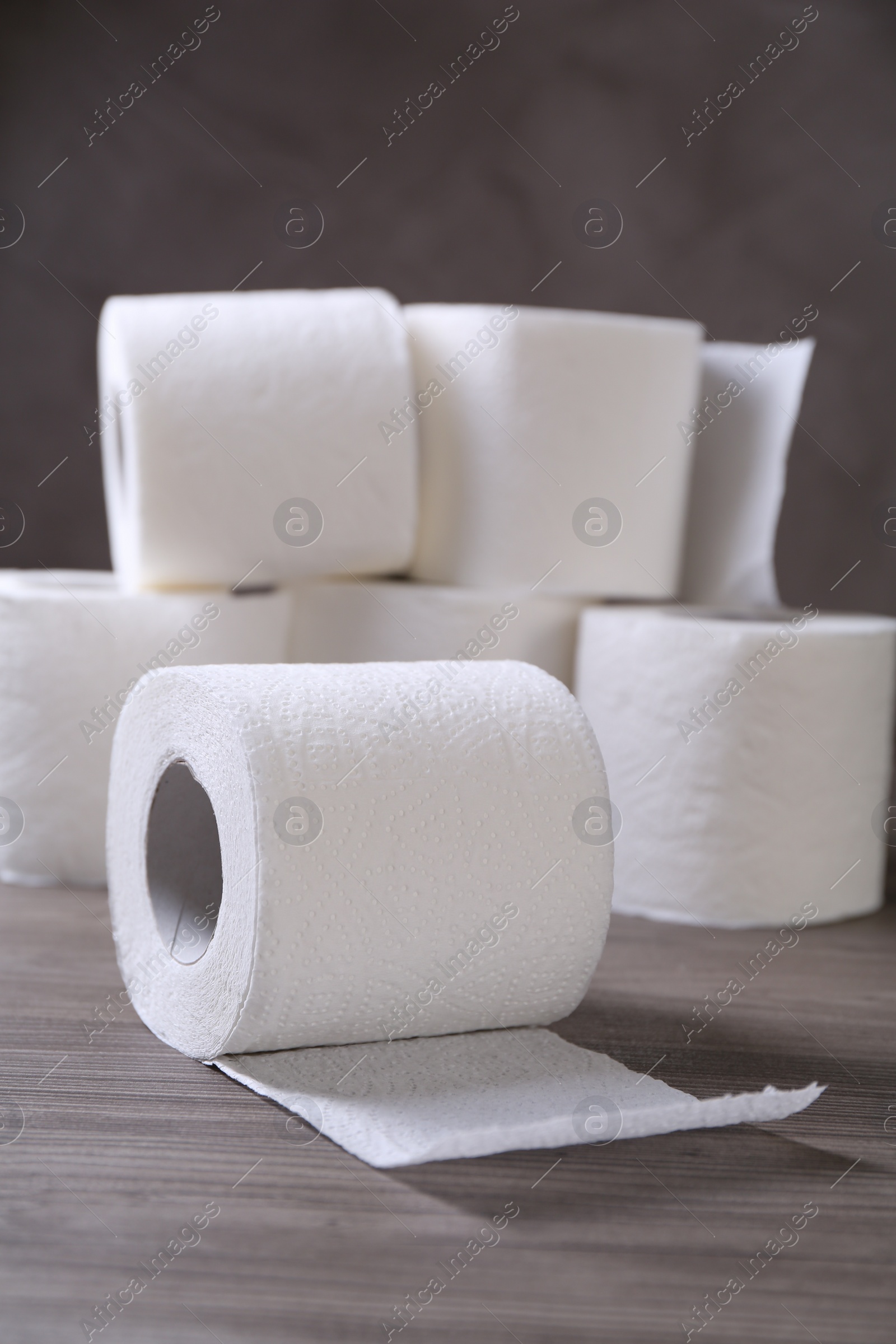 Photo of Soft toilet paper rolls on wooden table