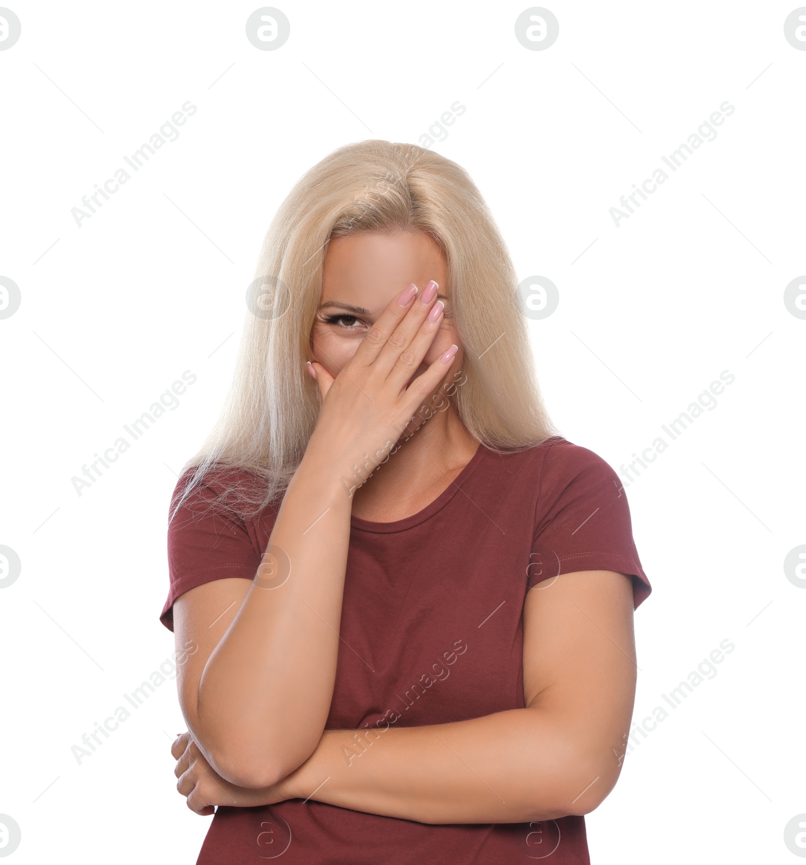 Photo of Embarrassed woman covering face with hand on white background