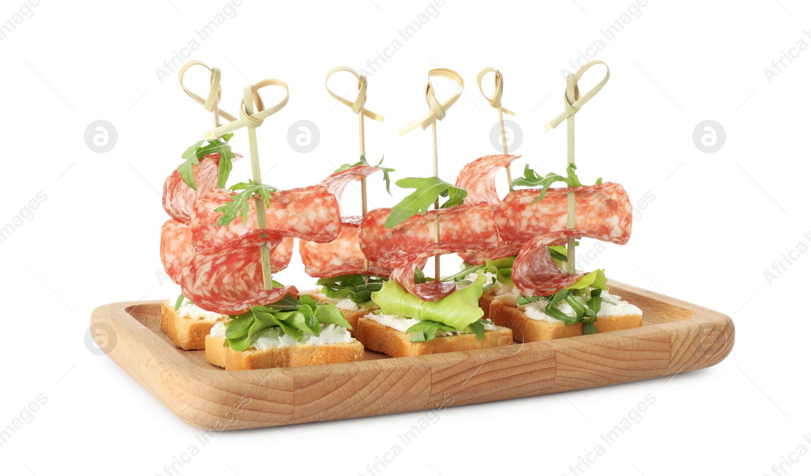 Photo of Tasty canapes with salami, greens and cream cheese isolated on white